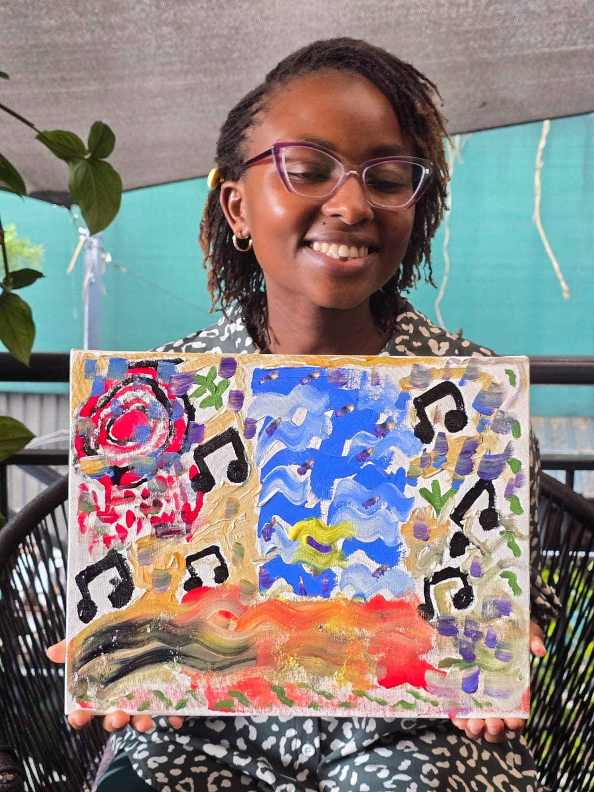 Participant with a colourful painting, October 2025