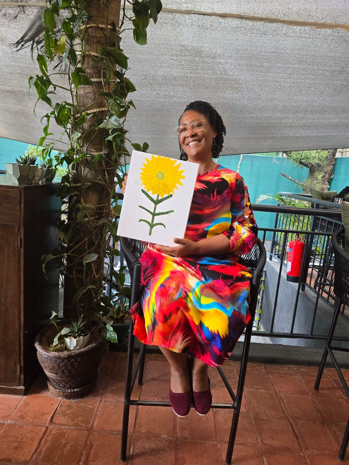 Participant with a sunflower painting, October 2025